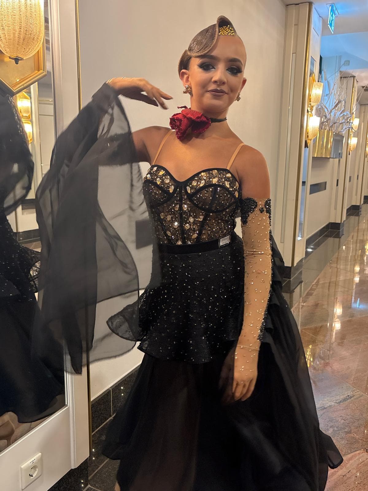 Young dancer in competition attire preparing backstage